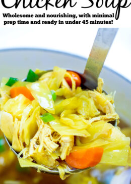 Pinterest pin with a dutch oven full of cabbage chicken soup topped with green onions, and a ladle scooping up the soup.