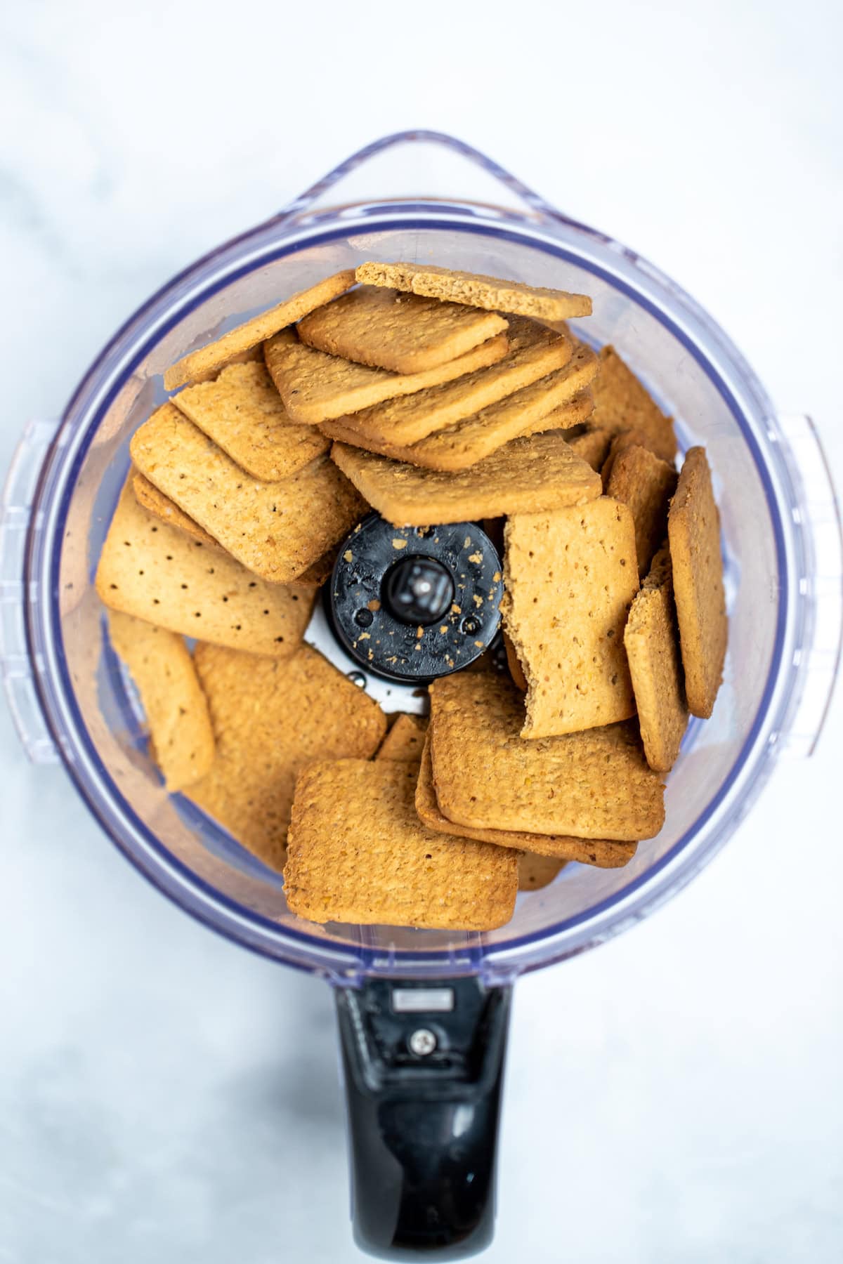 A food processor full of gluten free graham crackers, before processing.