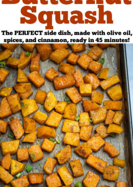 Pinterest pin with a sheet pan lined with parchment paper with a single layer of roasted butternut squash, topped with green onions.