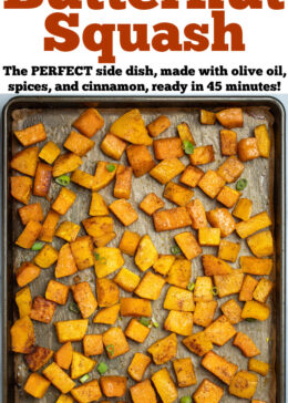 Pinterest pin with a sheet pan lined with parchment paper with a single layer of roasted butternut squash, topped with green onions.