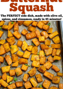 Pinterest pin with a sheet pan lined with parchment paper with a single layer of roasted butternut squash, topped with green onions.