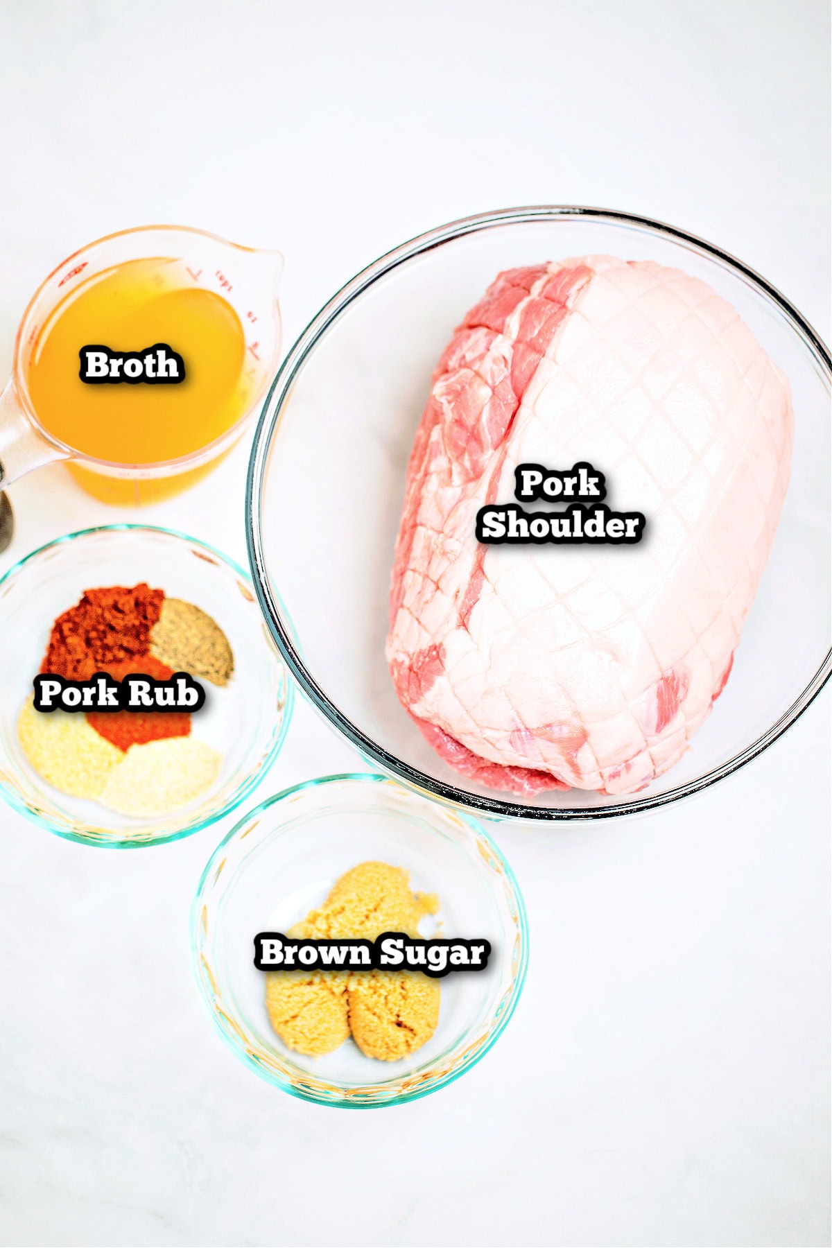 Individual ingredients for slow cooker pork shoulder on a table.