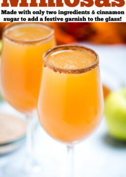 Pinterest pin with a wine glass filled with apple cider mimosas, with another wine glass on a table in the background.