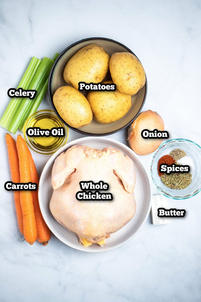 Individual ingredients for dutch oven whole chicken on a table.