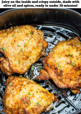 Pinterest pin with chicken thighs in an air fryer basket with chopped chives on top of crispy skin.