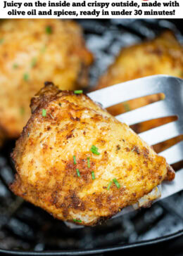 Pinterest pin with chicken thighs in an air fryer basket with chopped chives on top of crispy skin, with a spatula lifting one up.