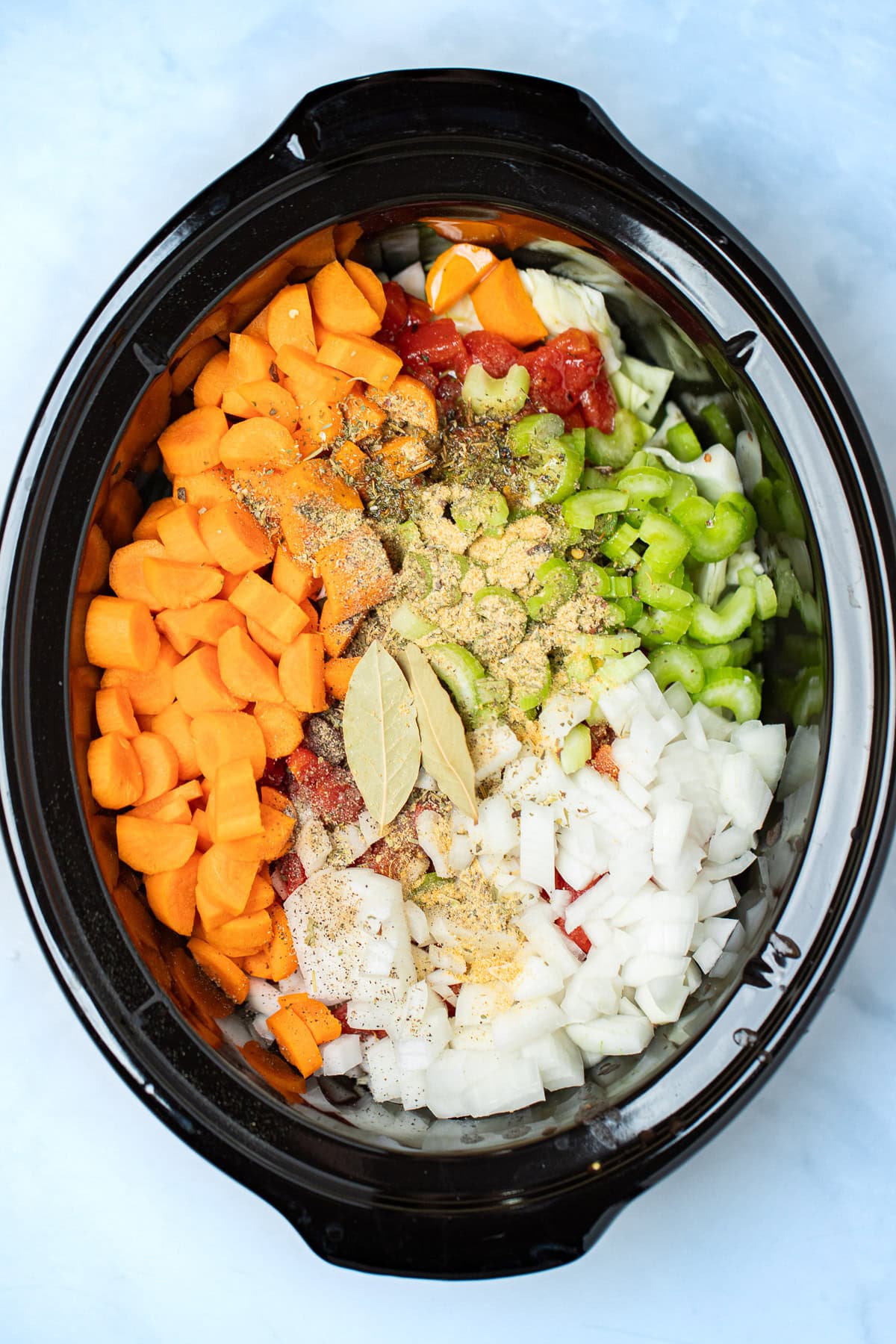 All of the ingredients for slow cooker cabbage soup in the crockpot before being cooked.