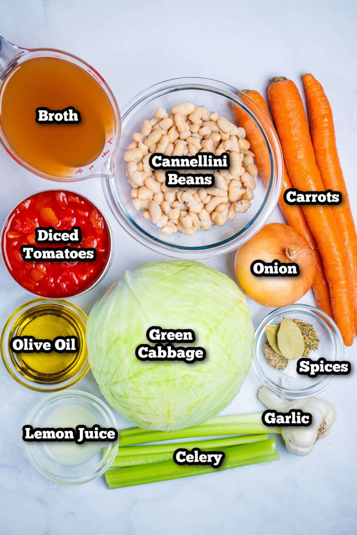 Individual ingredients for slow cooker cabbage soup on a table.