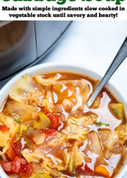 Pinterest pin with a bowl of slow cooker cabbage soup on the table, with a spoon in the soup, in front of a slow cooker.