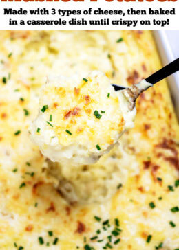 Pinterest pin with a casserole dish full of twice baked mashed potatoes with caramelized cheese on top with fresh chopped chives, with a spoon lifting some mashed potatoes up.