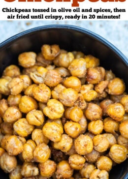 Pinterest pin with a bowl on a table with crispy air fryer chickpeas coated in seasoning.