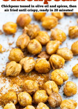 Pinterest pin with air fryer chickpeas on a table on top of seasoning.