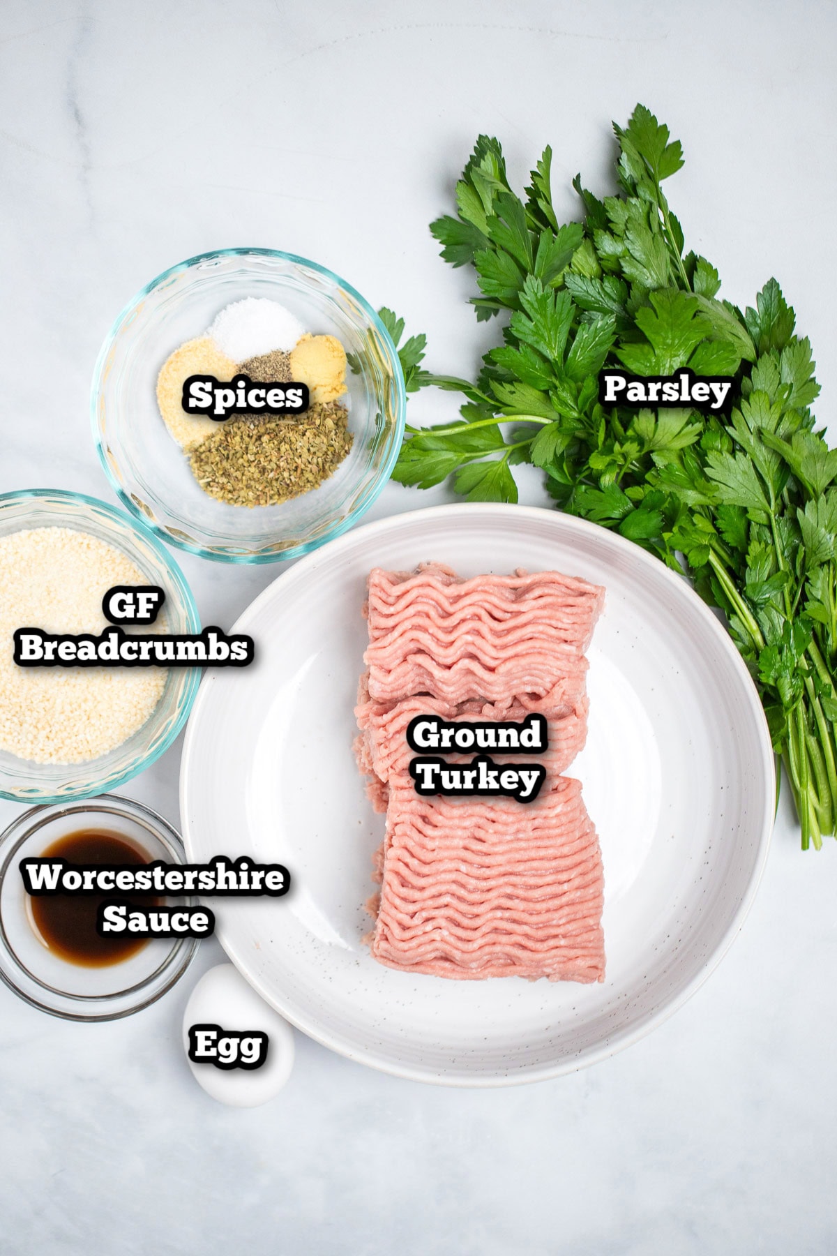 Individual ingredients for air fryer turkey meatballs on a table.