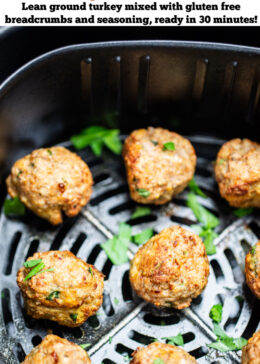 Pinterest pin with air fryer turkey meatballs in an air fryer basket after being cooked. They're brown and caramelized and topped with fresh parsley.