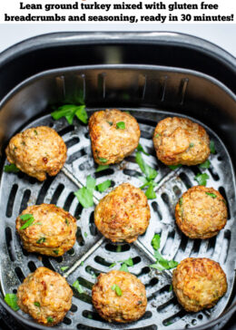 Pinterest pin with air fryer turkey meatballs in an air fryer basket after being cooked. They're brown and caramelized and topped with fresh parsley.