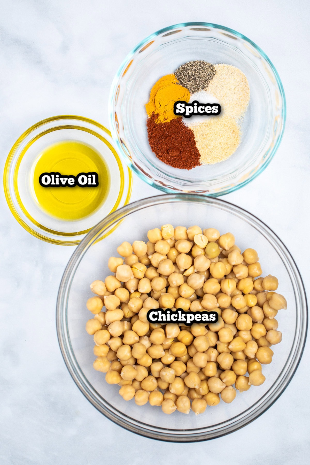 Individual ingredients for air fryer chickpeas on a table.