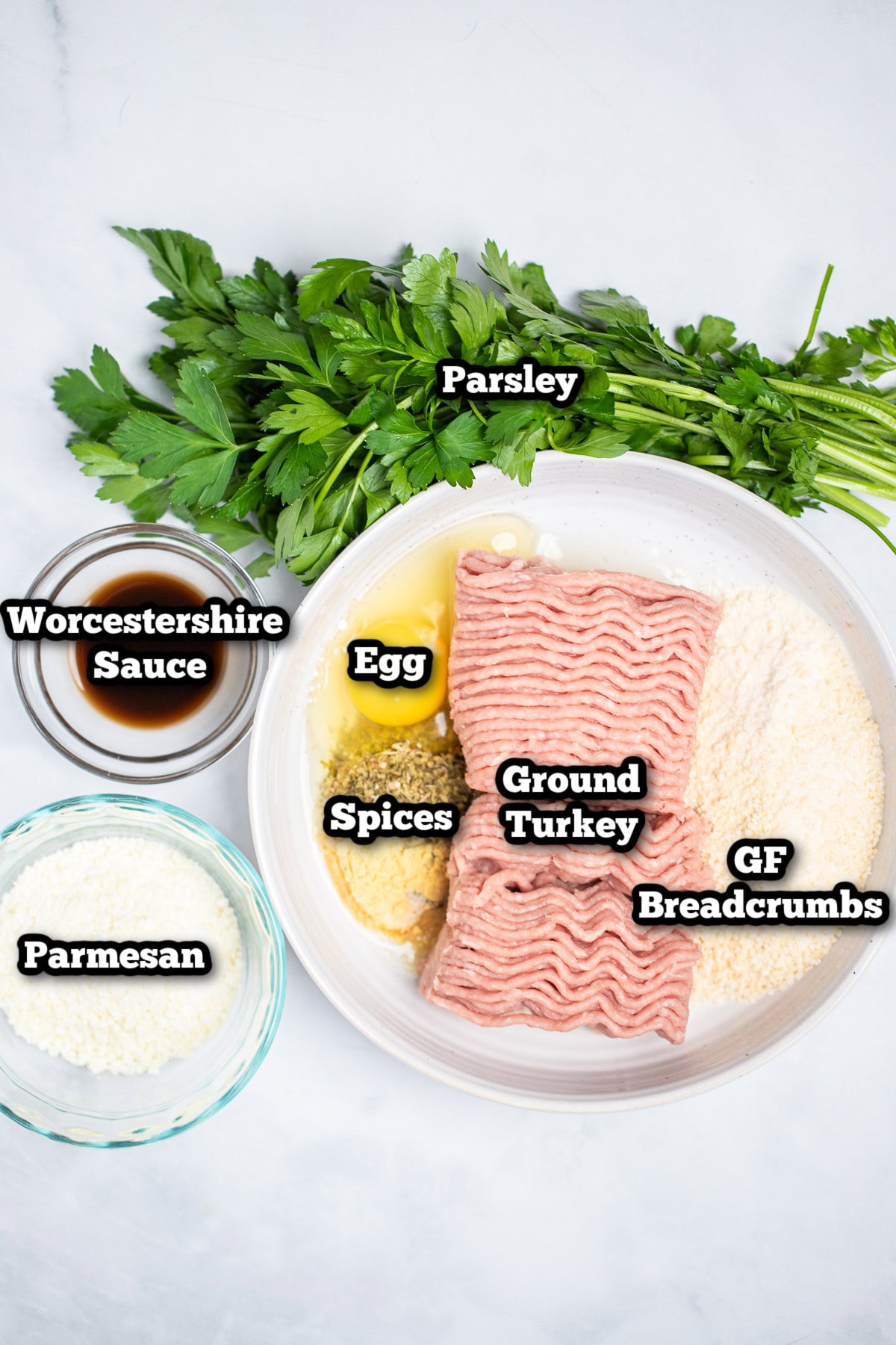 Individual ingredients for baked turkey meatballs on a table.