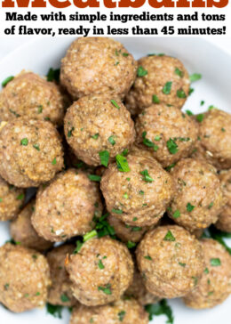 Pinterest pin with a bowl full of baked turkey meatballs topped with fresh chopped parsley, on a table.