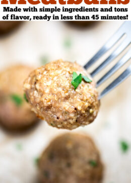 Pinterest pin with baked turkey meatballs on a sheet pan lined with parchment paper, fully cooked and topped with fresh chopped parsley, with a fork lifting one meatball up.