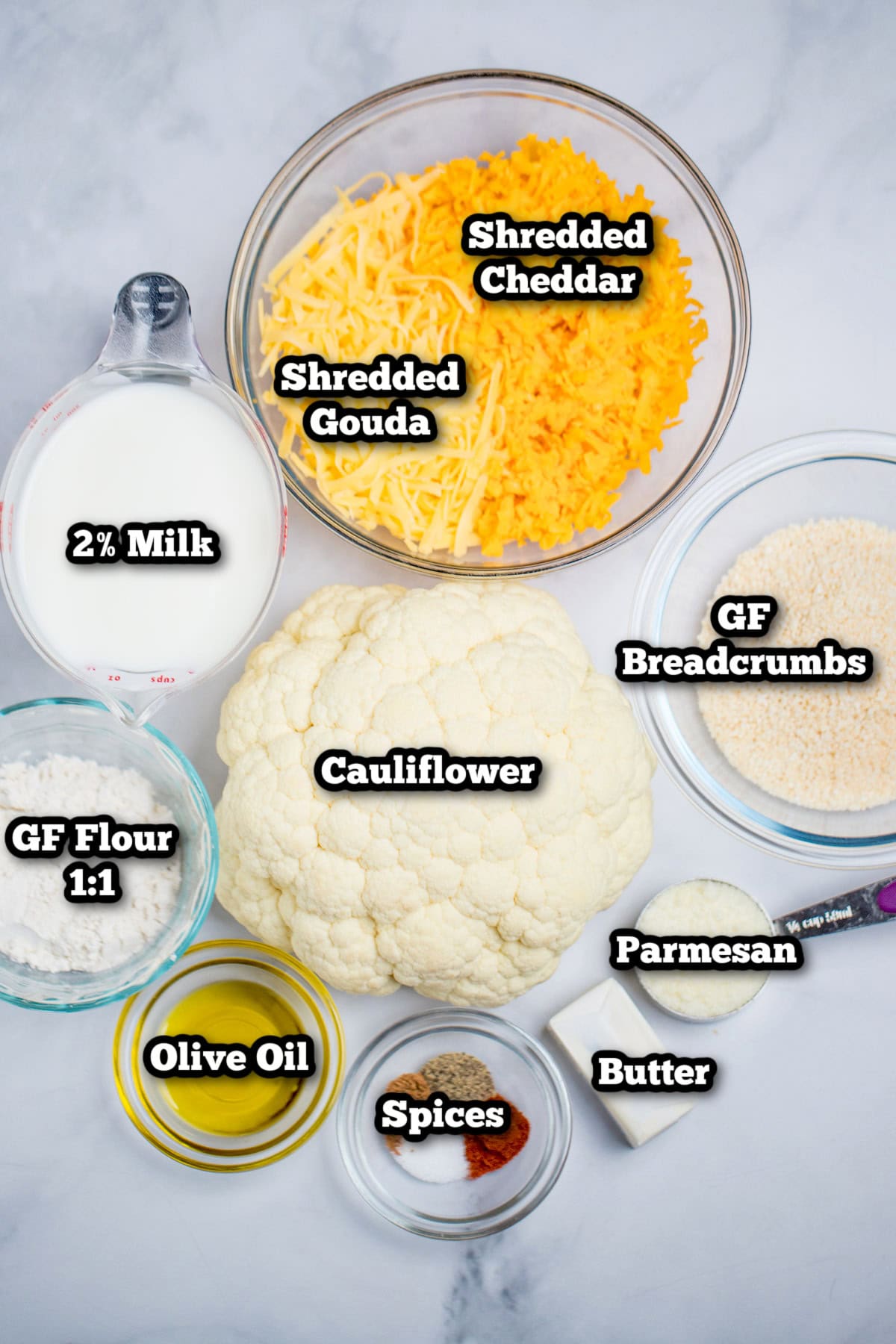 Individual ingredients for cauliflower mac and cheese on a table.