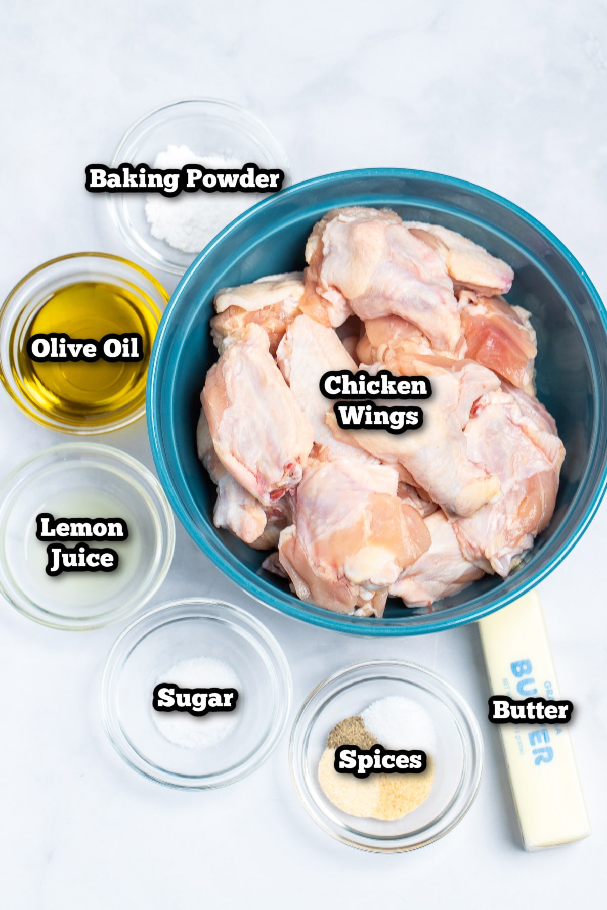 Individual ingredients for lemon pepper wings on a table.