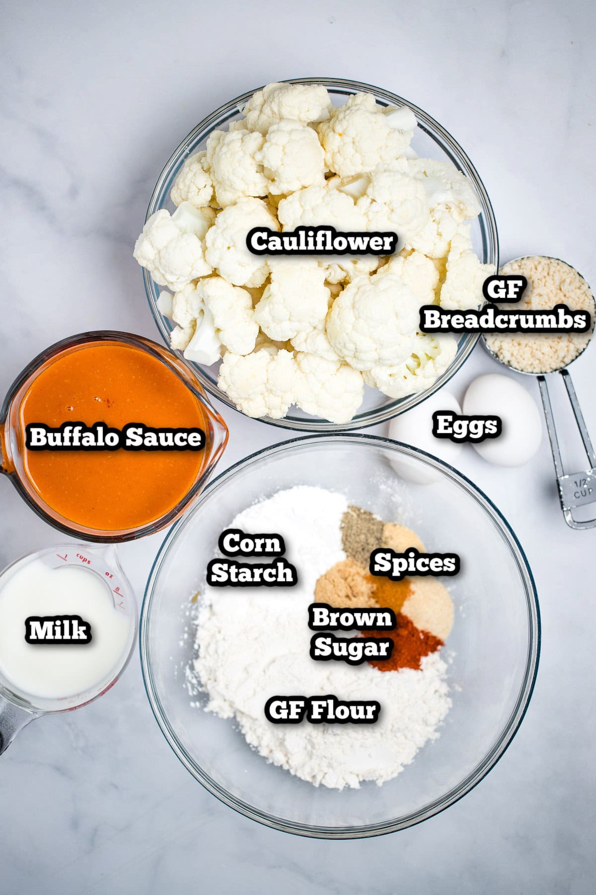 Individual ingredients for buffalo cauliflower wings on a table.