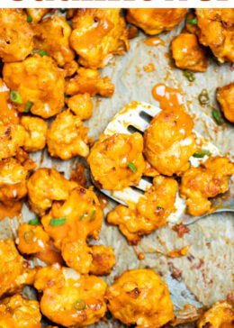 Pinterest pin with Buffalo Cauliflower Wings on a sheet pan lined with parchment paper and a spatula holding some cauliflower, resting on the sheet pan, topped with extra buffalo sauce and green onions.