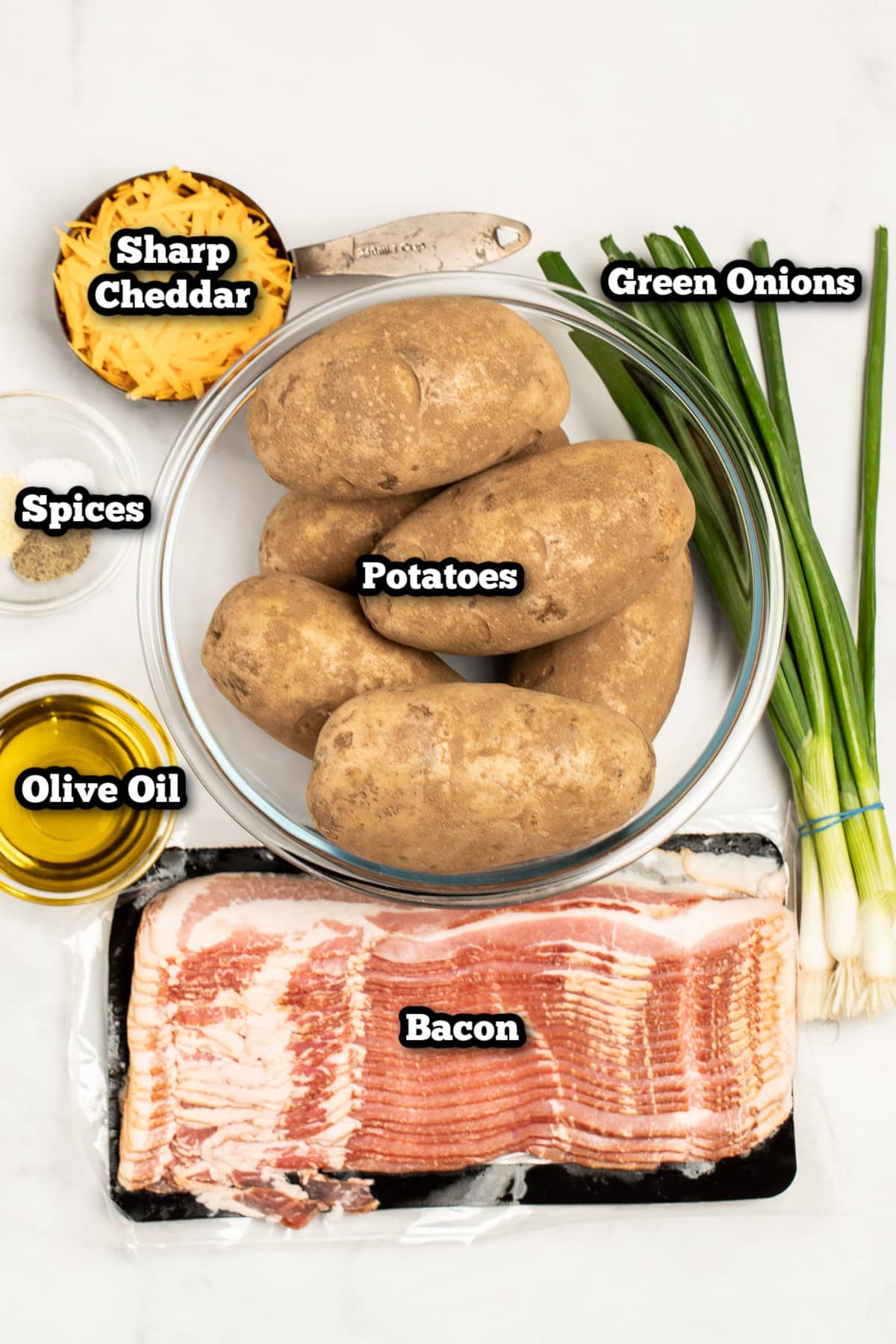 Individual ingredients for loaded potato skins on a table.