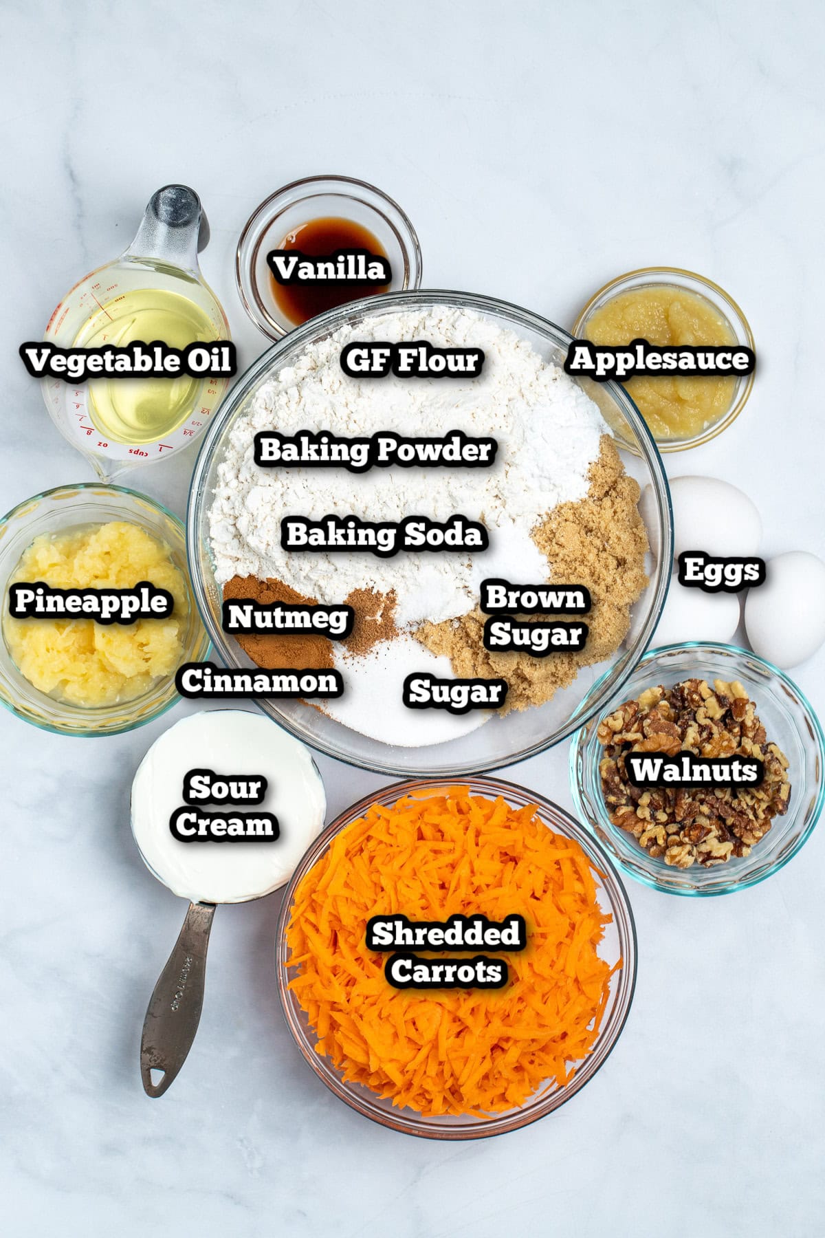 Individual ingredients for gluten free carrot cake on a table.