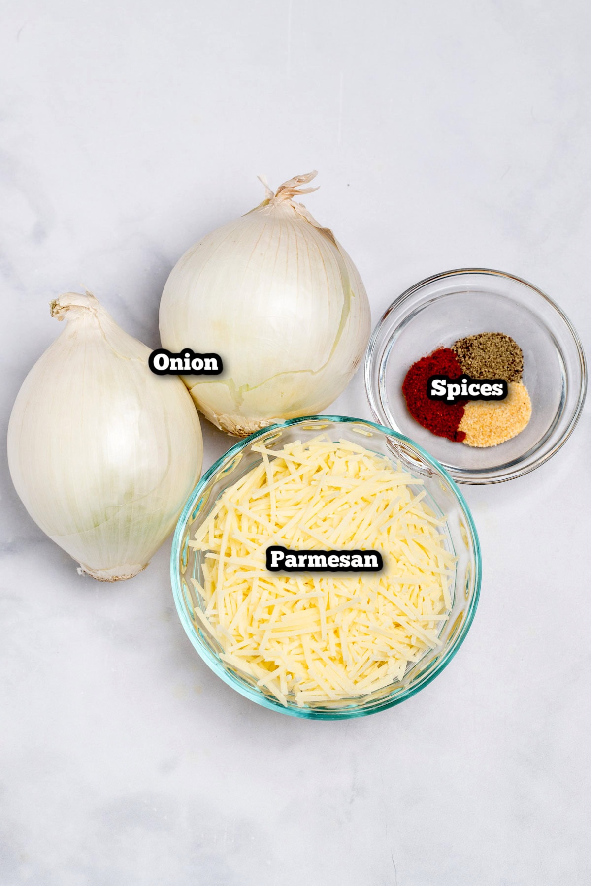 Individual ingredients for parmesan onion ring chips on a table.